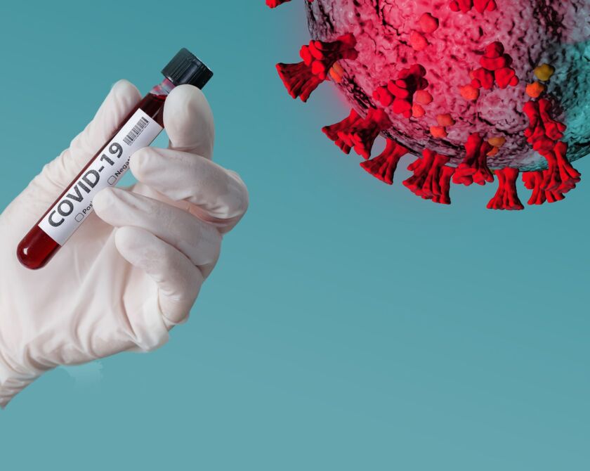 Illustration zeigt das Corona-Virus mit einer Blutampulle