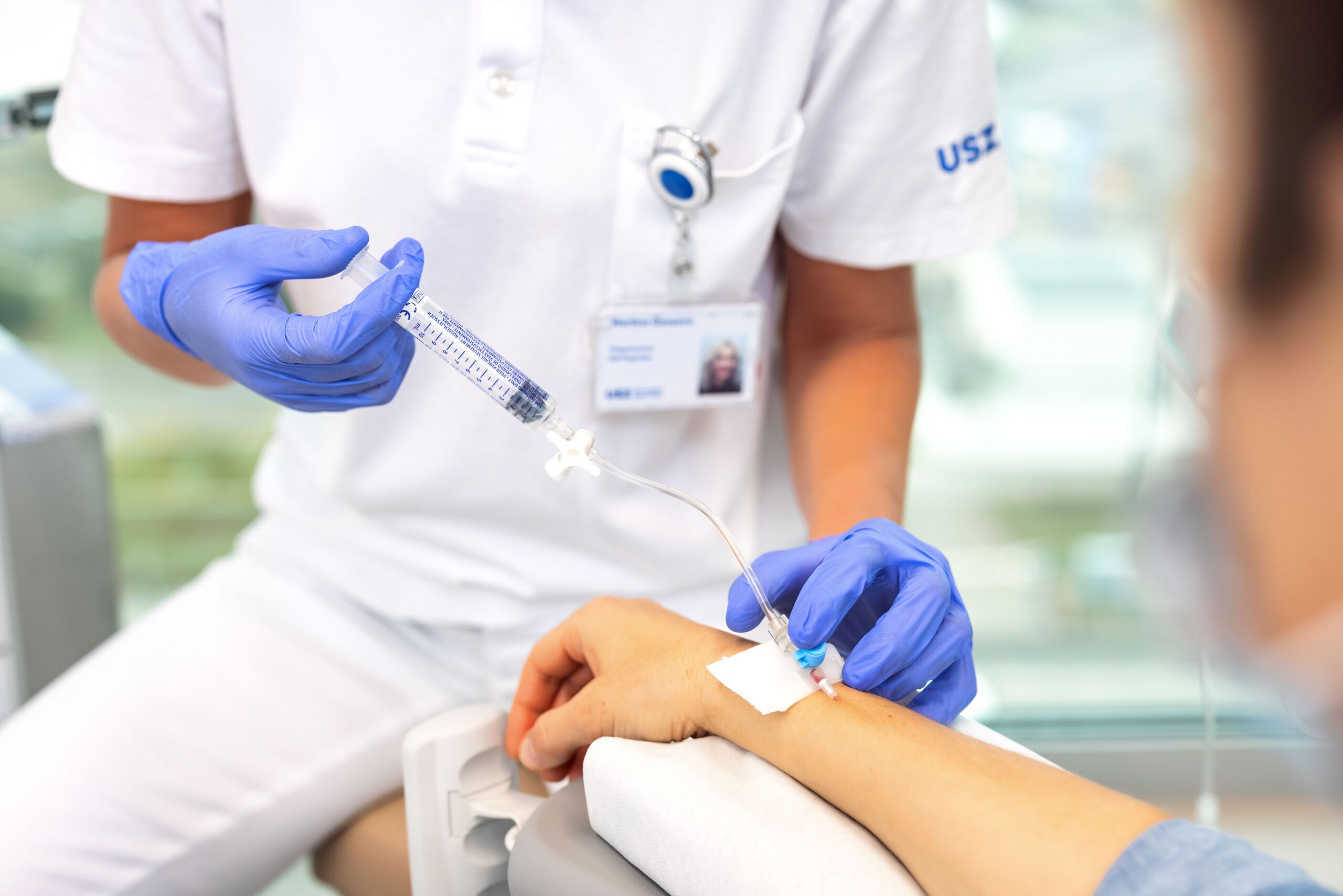 Patient receives an infusion via the right arm.