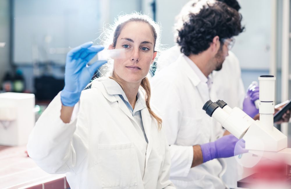 Scientist Looking At A Microscope