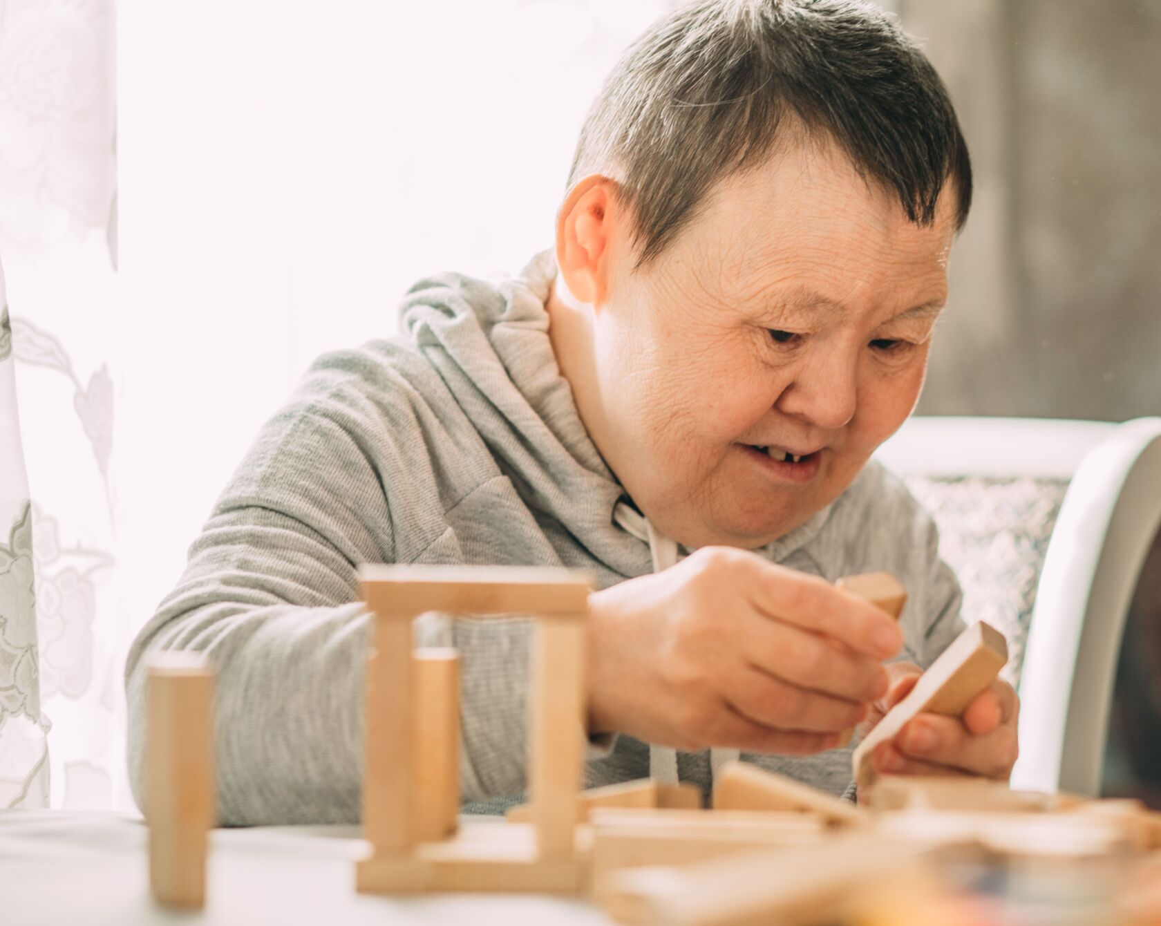 Patient mit Trisomie 21 beim Spielen.